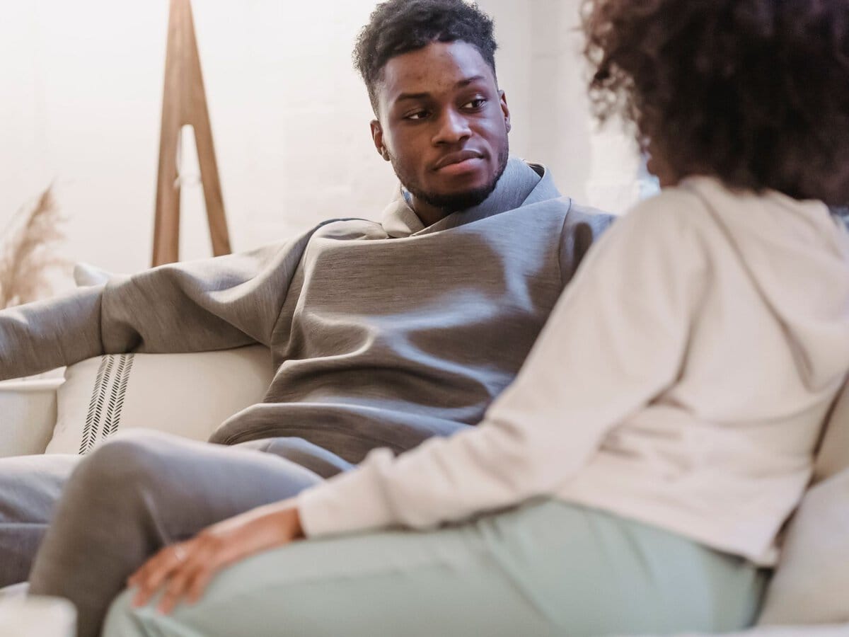 A man listening to his partner during a conversation at home