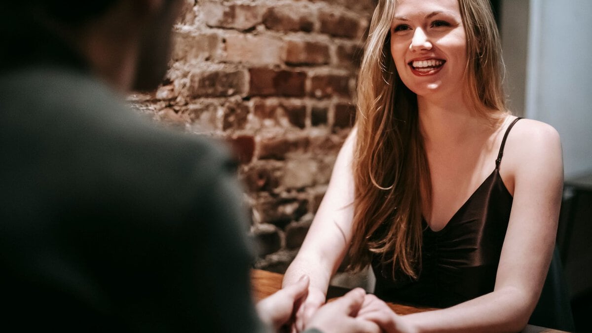 A woman smiling during a restaurant date