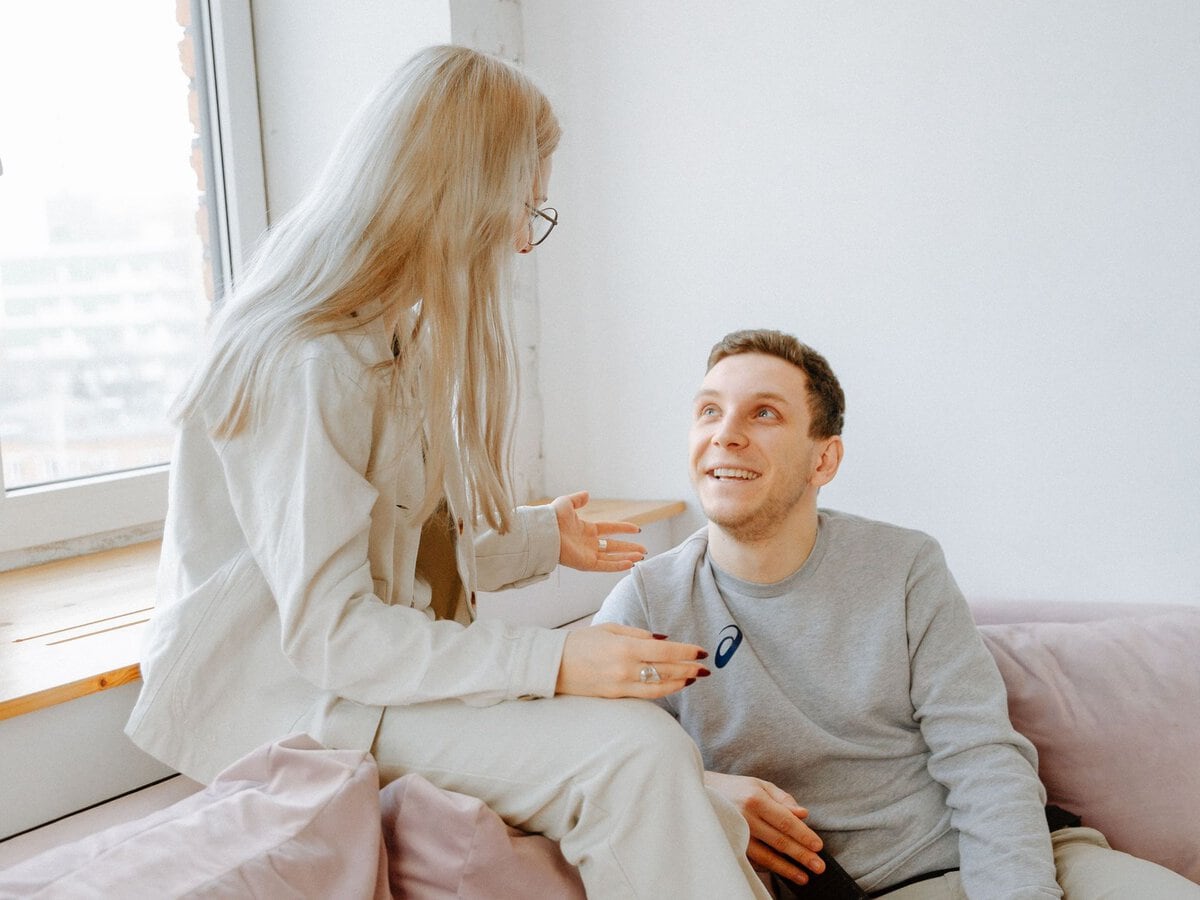 A couple talking together on a sofa
