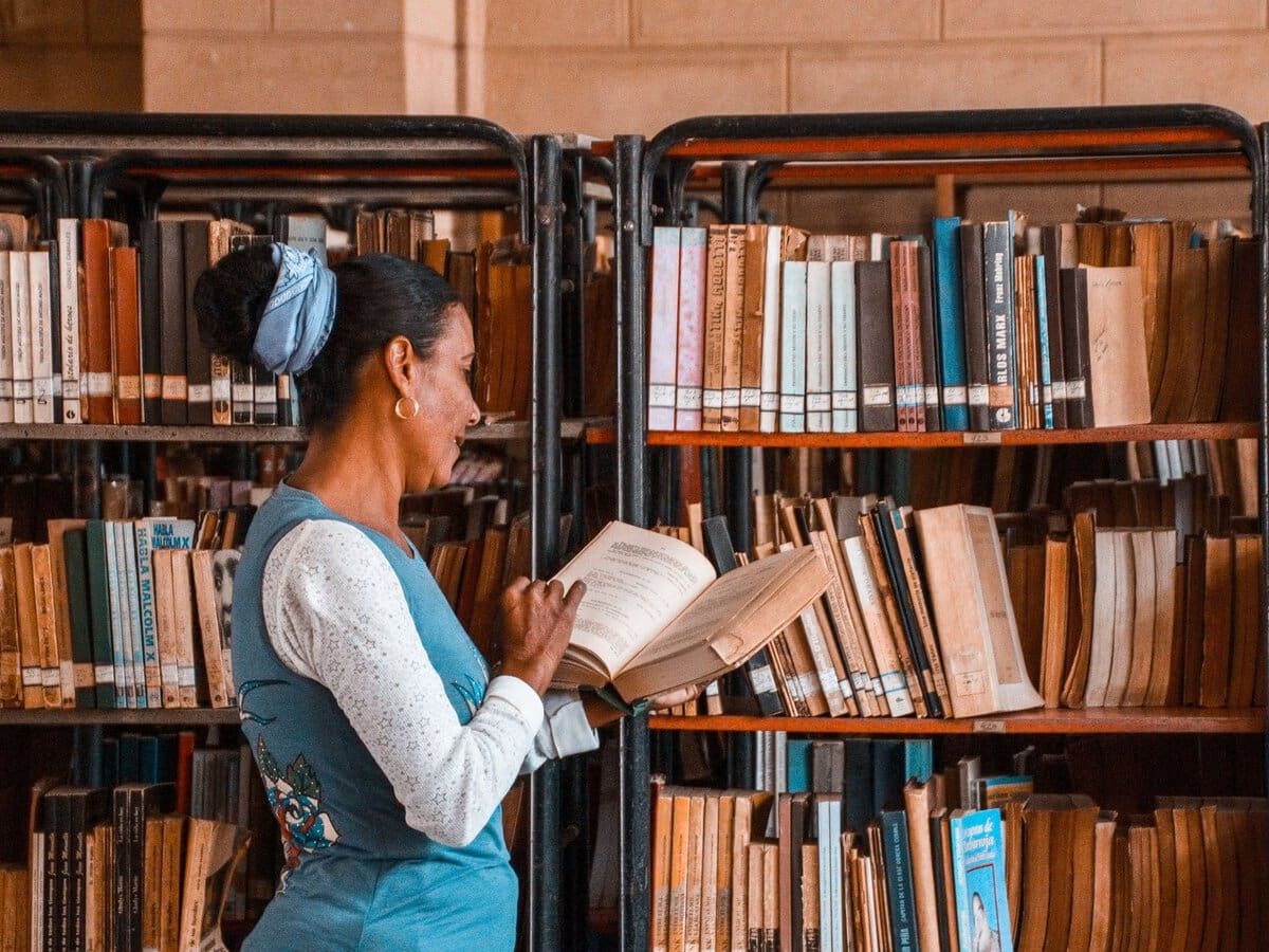 A woman browsing a book in a library