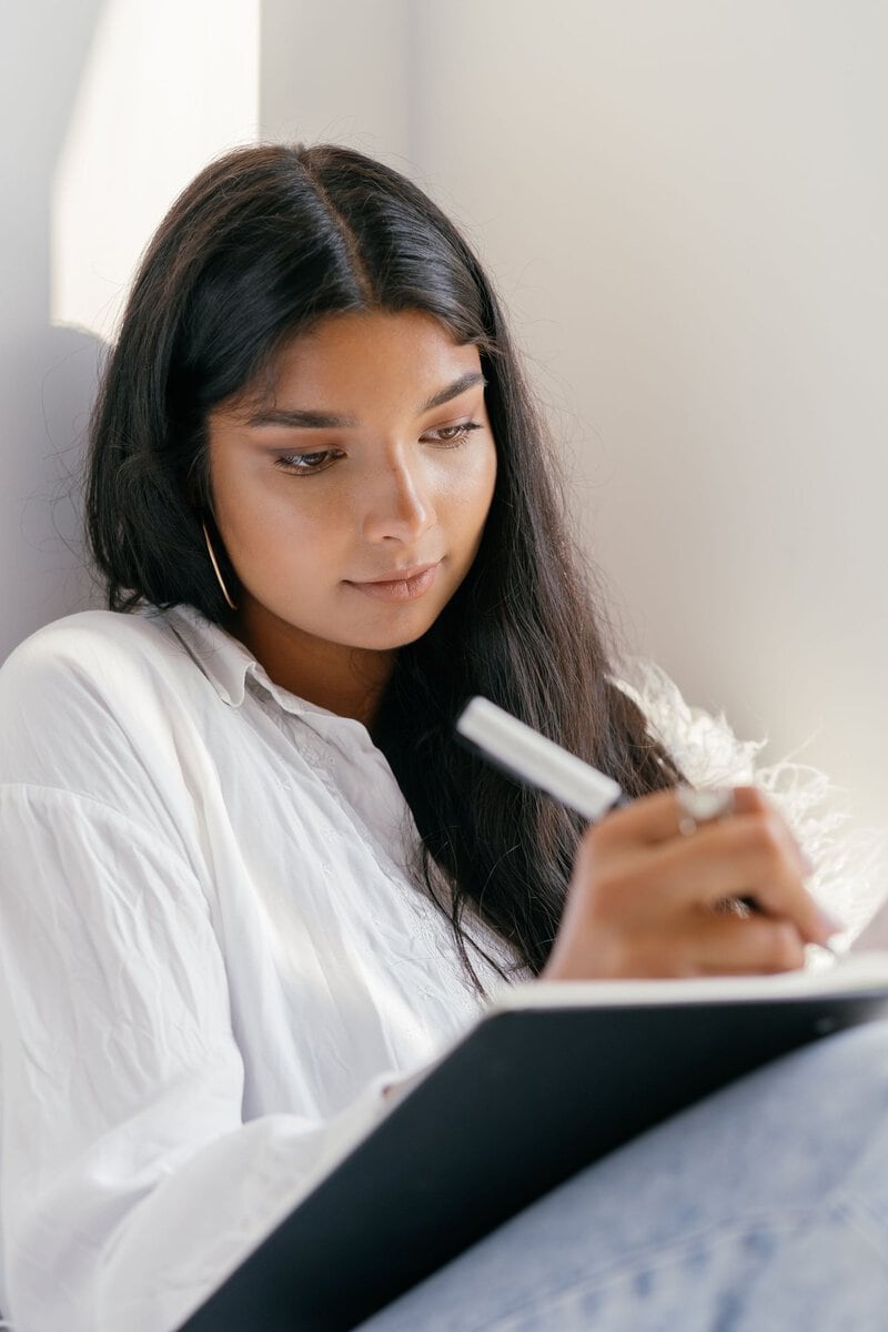 Woman preparing notes in a notebook