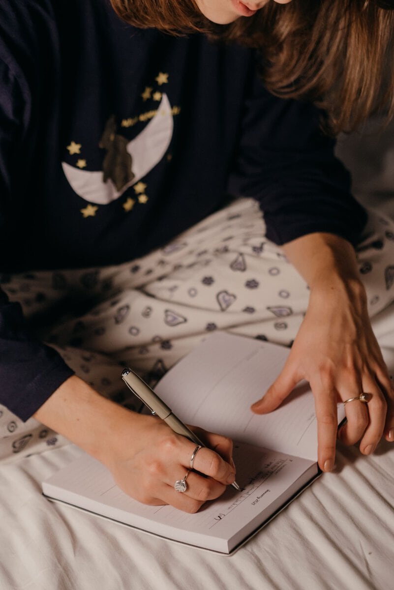 Woman writing a plan in her notebook