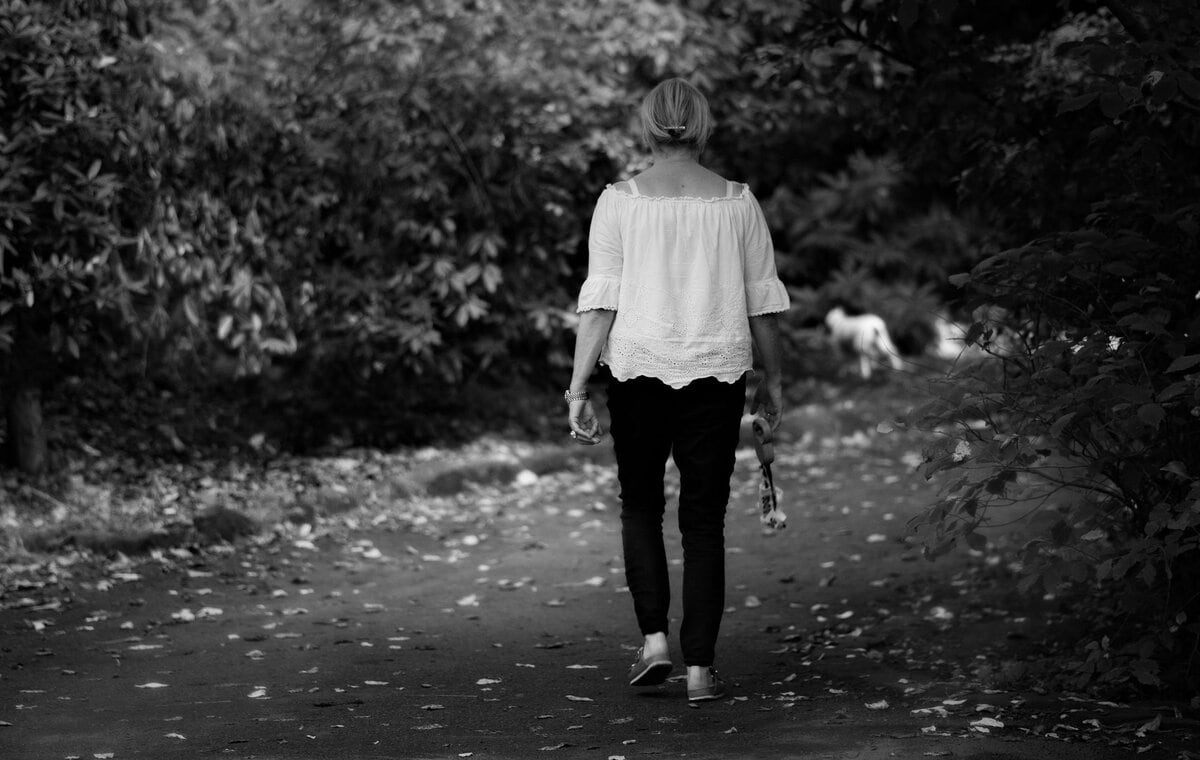 A walker on a quiet path in black and white