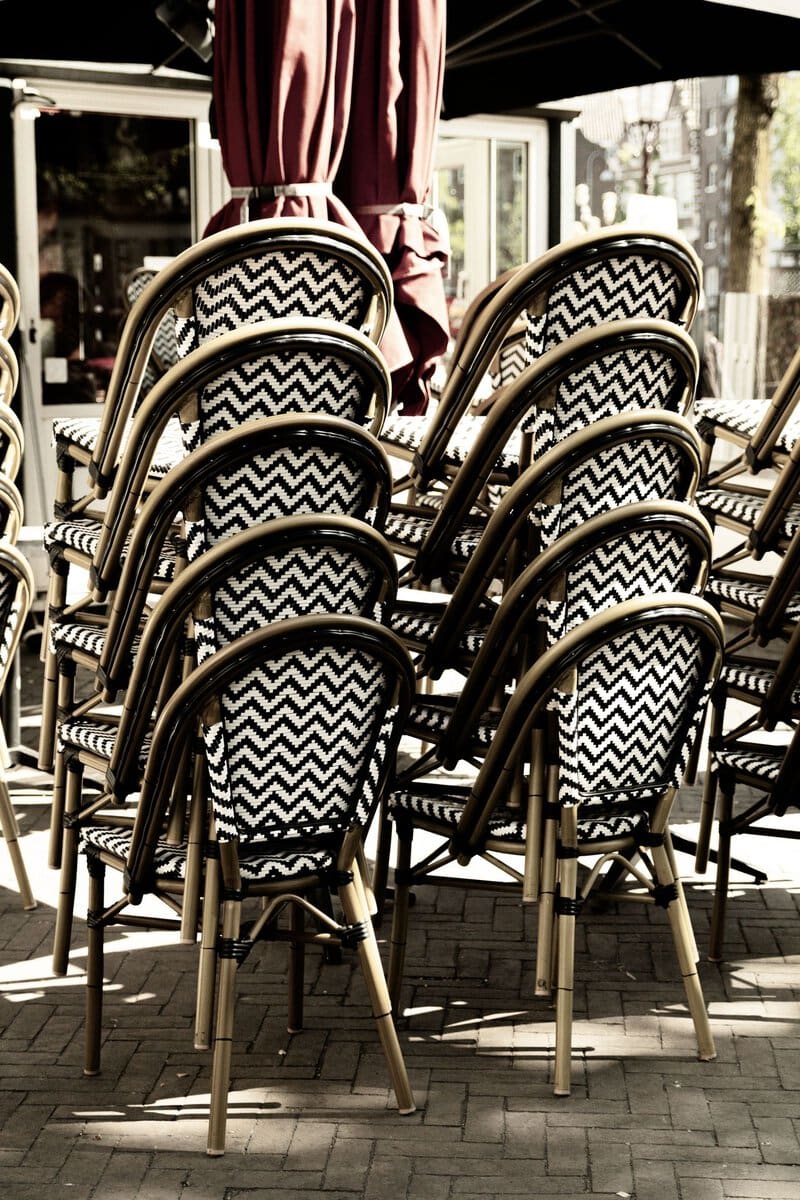 Cafe chairs stacked in sunlight
