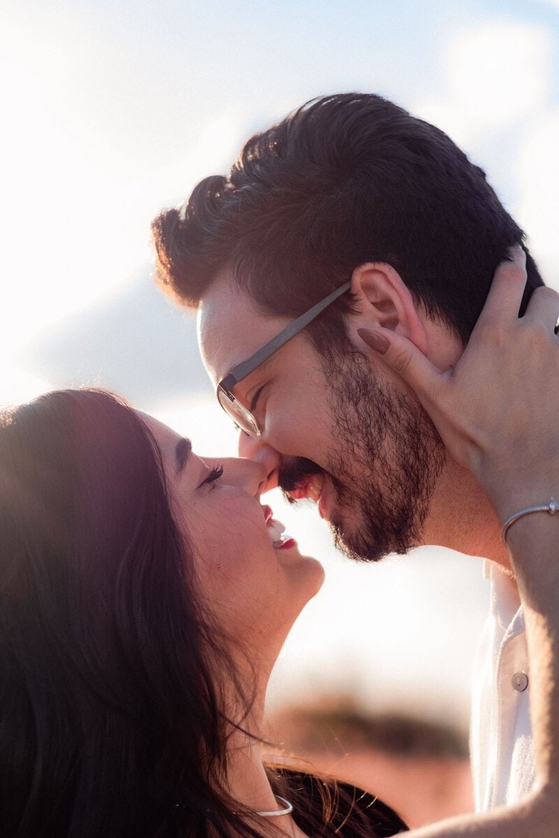 Couple sharing a kiss in warm evening light