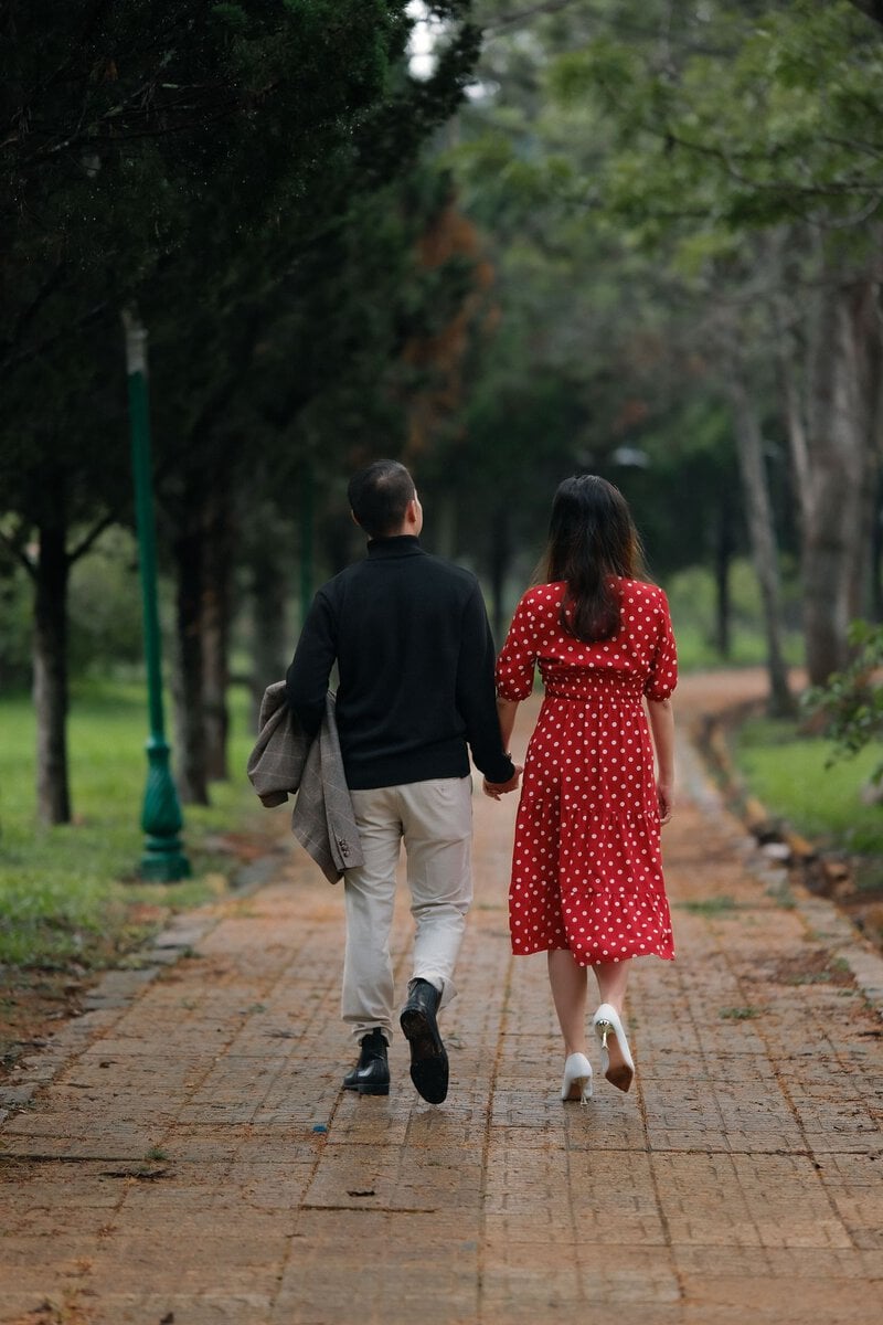 Couple walking together along a park path