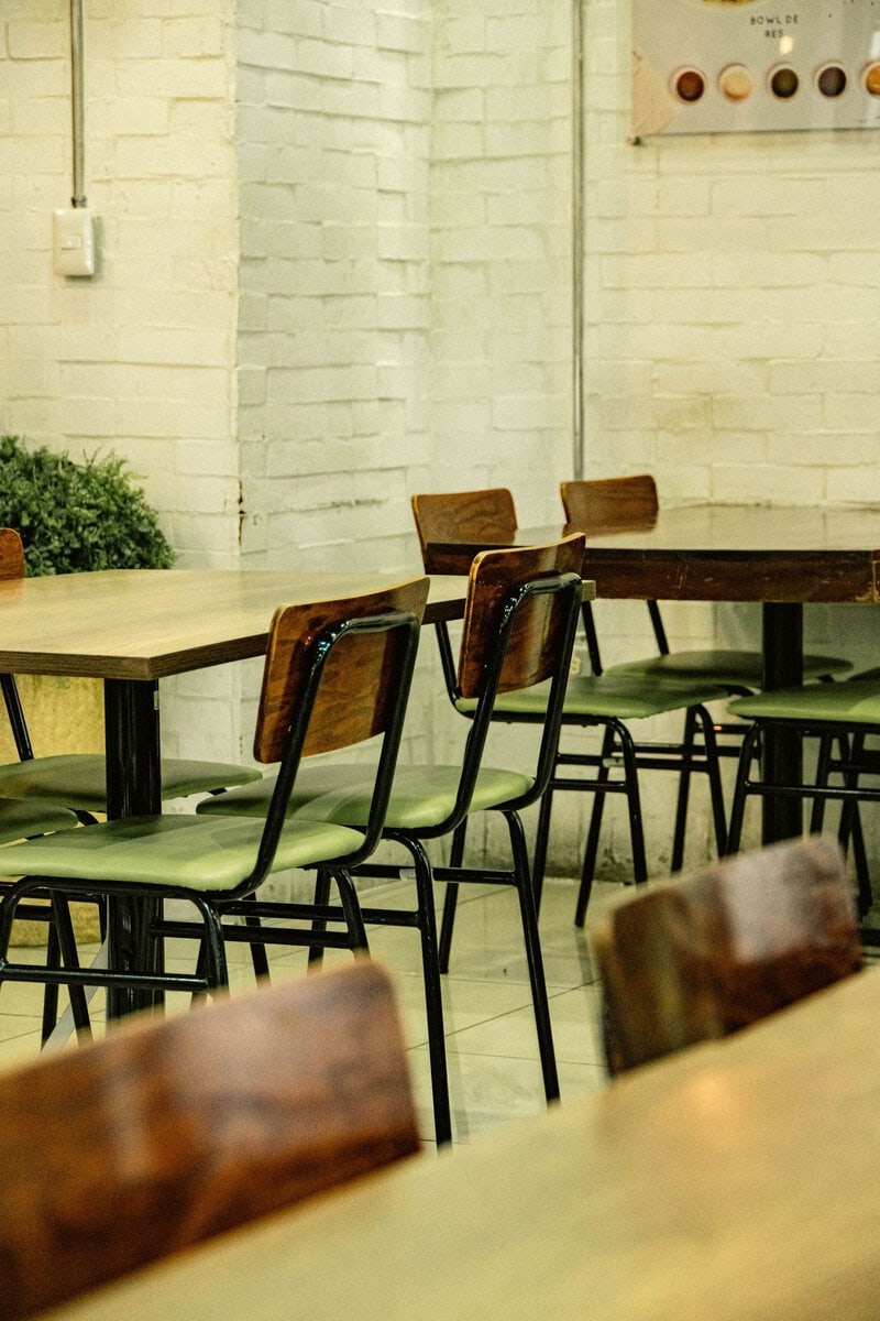Empty diner tables with wooden chairs