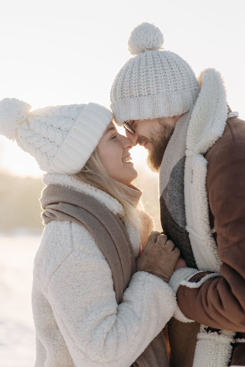 Couple embracing in knitted winter hats