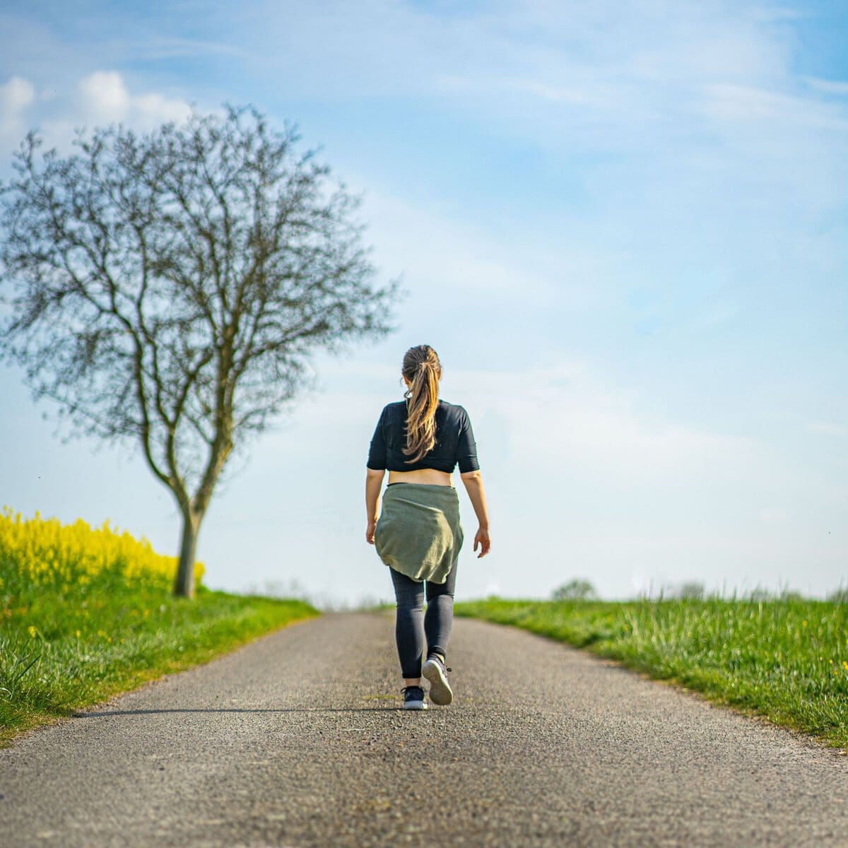 Woman walking along a quiet rural path