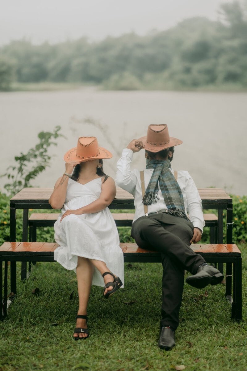 Couple sitting together on a bench by a lake