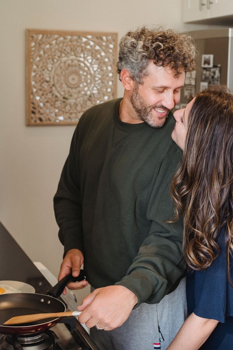 Couple smiling together in a kitchen