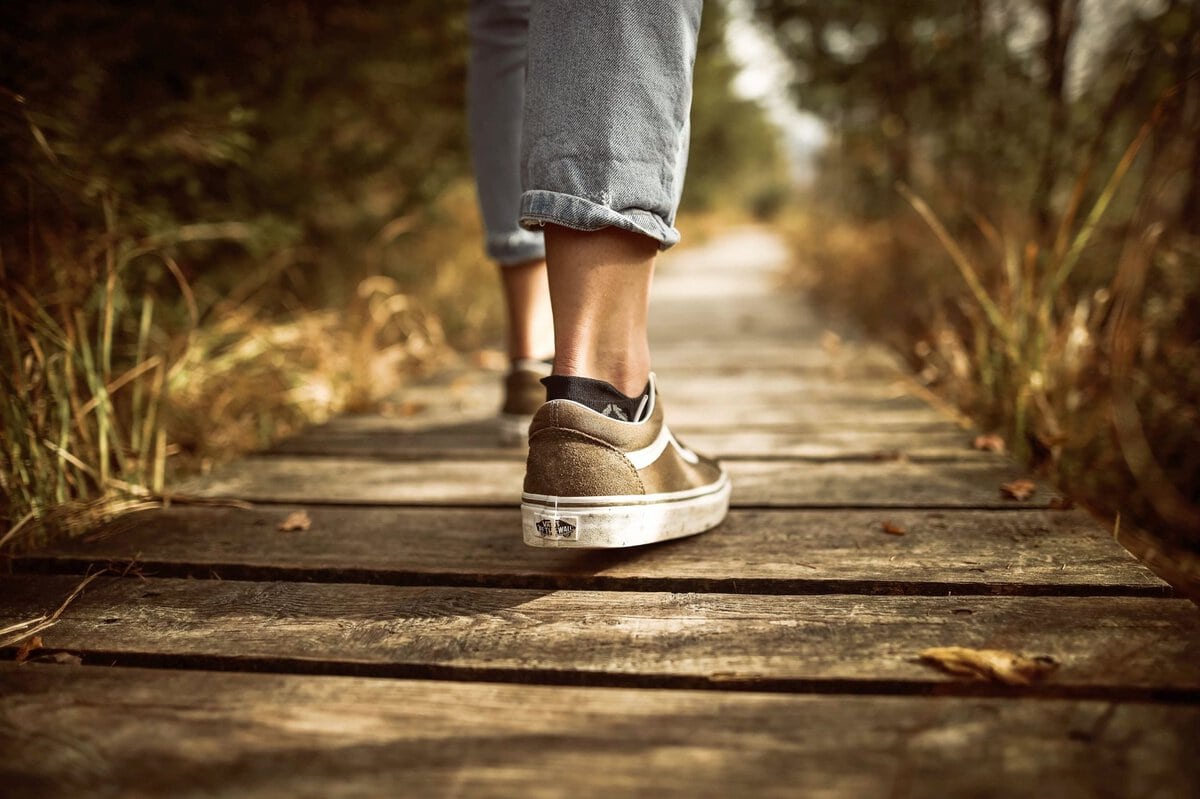Person walking along a wooden path