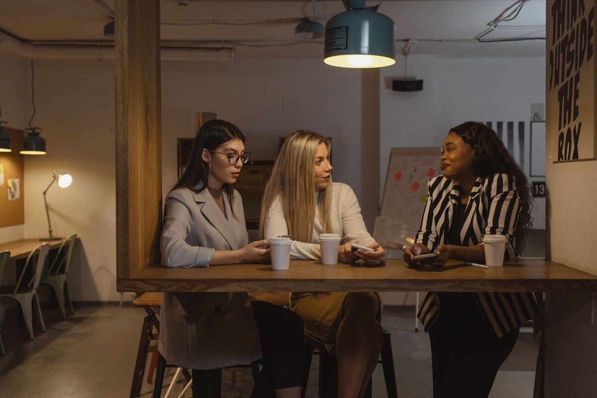 Three women talking over coffee